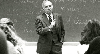 Former President Lawry Gulick teaching in front of a classroom of students