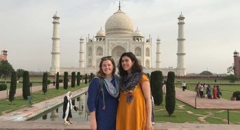 Two students standing in front of the Taj Mahal during their study abroad experience.