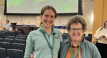 two females at conference smiling for picture