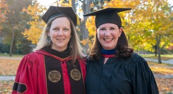 President Kathryn Morris and Jennifer Curley Reichert wearing academic regalia.