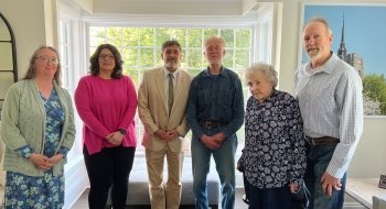 three women and three men posing for picture