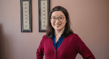 Grace Huang wearing a scarlet sweater.