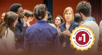 St. Lawrence students engage in conversation with an alumna at a networking event. Badge overlay reads “The Princeton Review No. 1 Alumni Network 2025.”