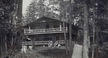 A digitized photo of Camp Pine Knot, a large, rustic Adirondack camp built in the Adirondack style.
