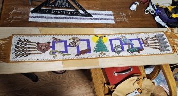 The Gathering of Nations, a stunning 42-inch beaded belt by Akwesasne Mohawk artists Kelly Tsieriwaiens Back and Tyson Karonhiahere Back from Fire Loom Creations.