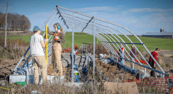 Students helping construct St. Lawrence University's greenhouse on the living laboratory
