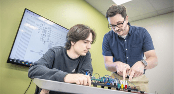 Assistant Professor of Computer Science Kevin Angstadt ’14 works with a student in the Cybersecurity lab.