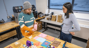 Assistant Professor of Mathematics Gabriel Dorfsman-Hopkins working with a student in the Explore Lab Makerspace