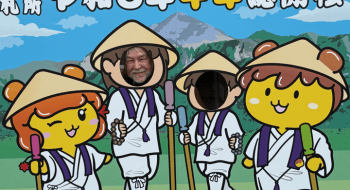 Dr. Mark MacWilliams posing with pilgrimage-themed characters during his summer 2026 trip to Japan