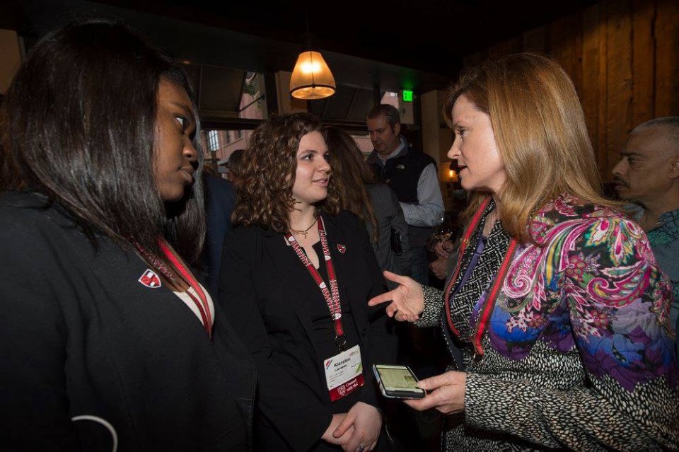 Alumna speaking with students