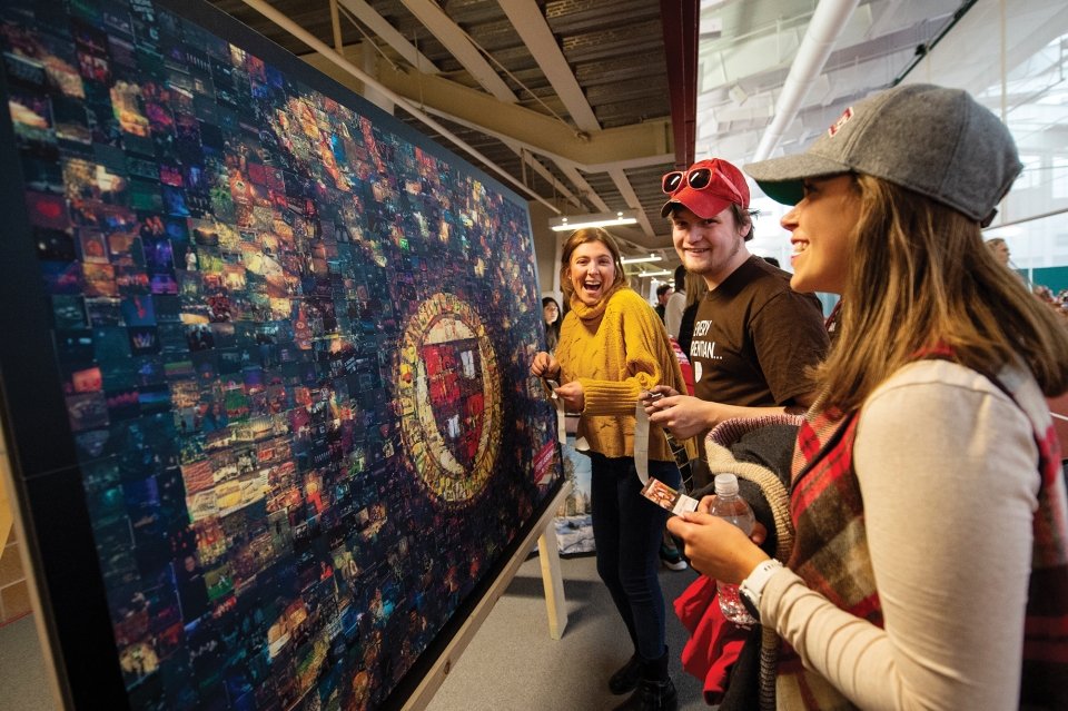 A photo of students looking at the mural that was the header of this article with awe.