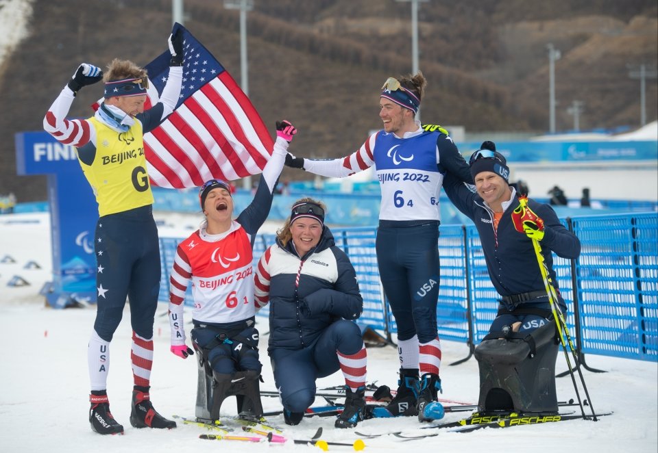 A photo of the Olympian ski team outside in action. 