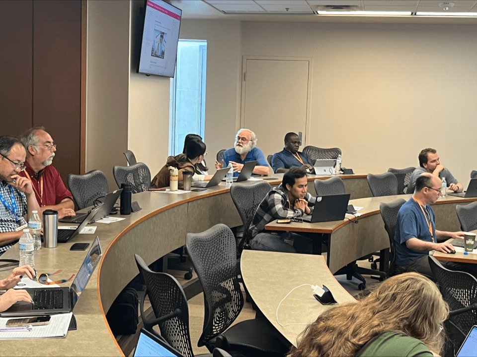 A photo of  Dr. Lock interacting with SCORE workshop participants. 