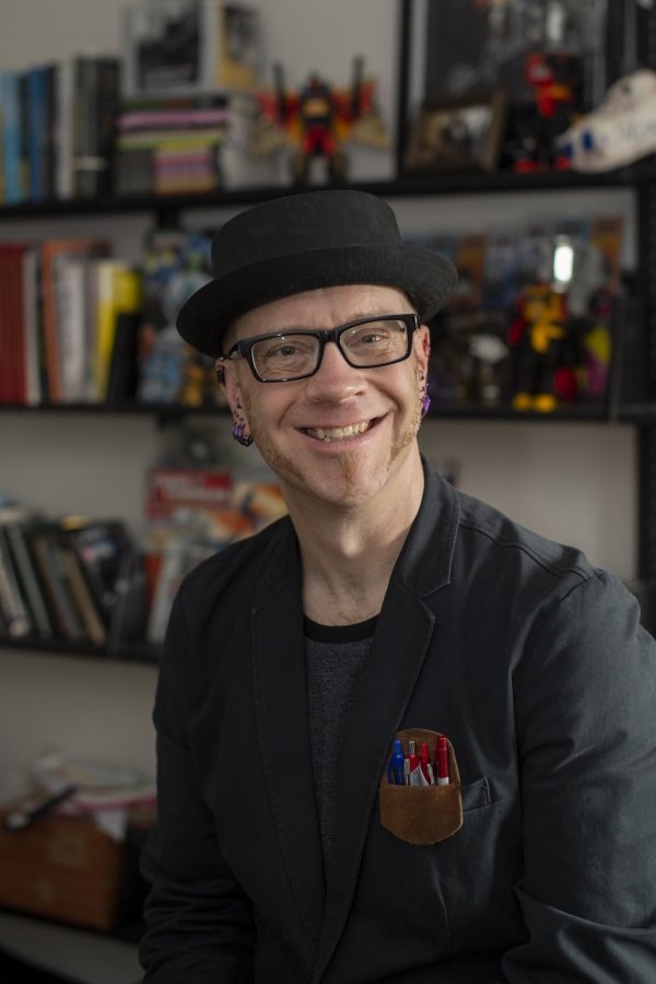 Man in hat and glasses smiling