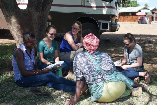 Students sitting under tree in Kenya