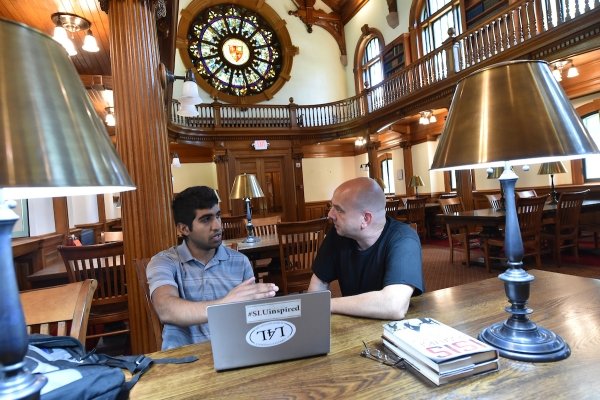 A Saint Lawrence professor and a student discuss an assignment in Herring Cole, the University's original library.
