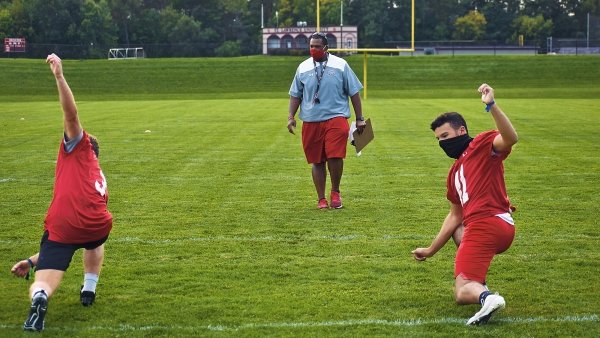 Football coach leading practice