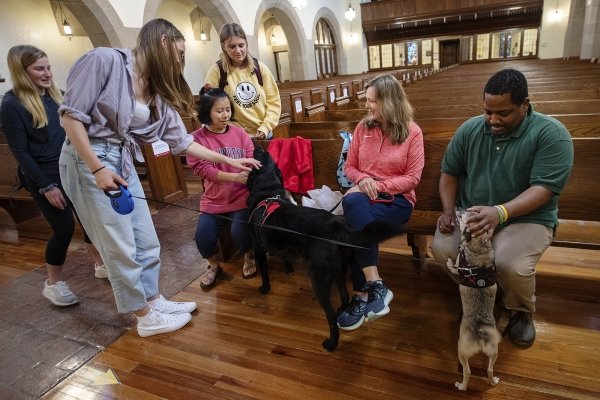 President Morris speaking with students in the chapel during doggy destress day