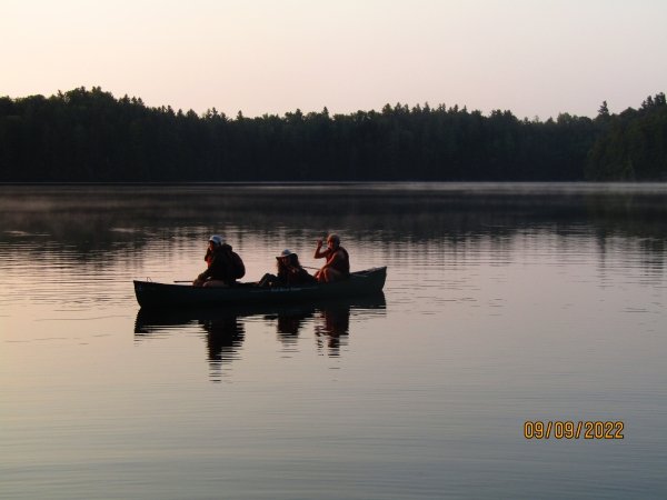 Three Arcadians in a canoe, ready to paddle to the van.