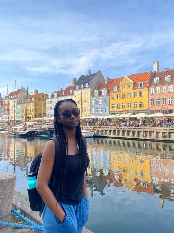 Student stands by the iconic Nyhavn in Copenhagen
