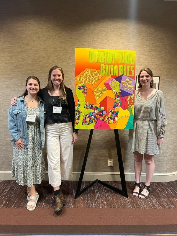 Students standing with conference poster