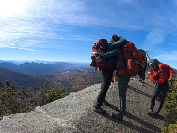 Hannah and Ella embrace upon reaching Gothics summit.