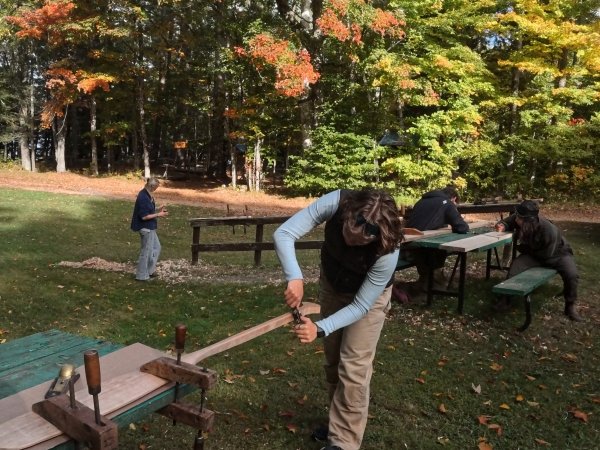 Marina Garlick carefully shaping her paddle in woodworking class.
