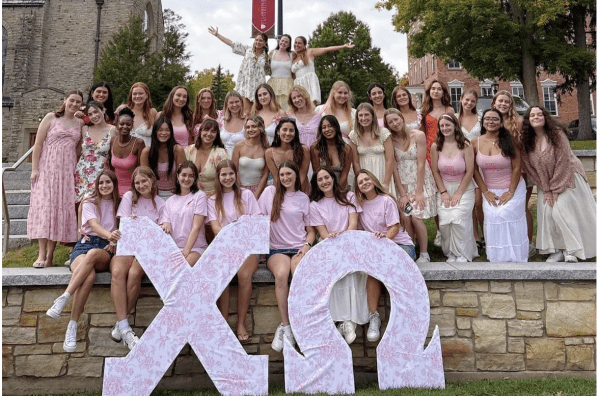 Chi Omega Members on the quad with their wooden letters