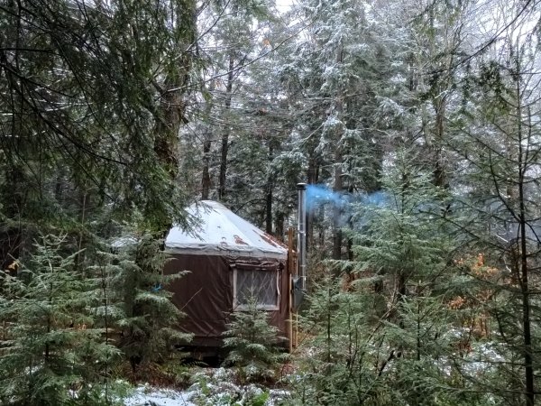 Smoke emerging from a yurt’s chimney.