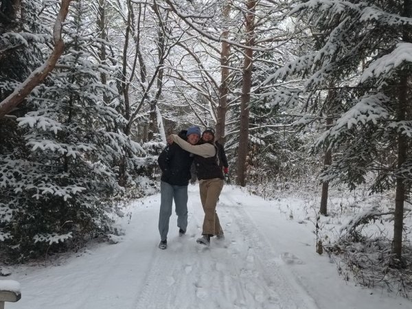 Arcadians Beckley and Garen hugging in the snow.
