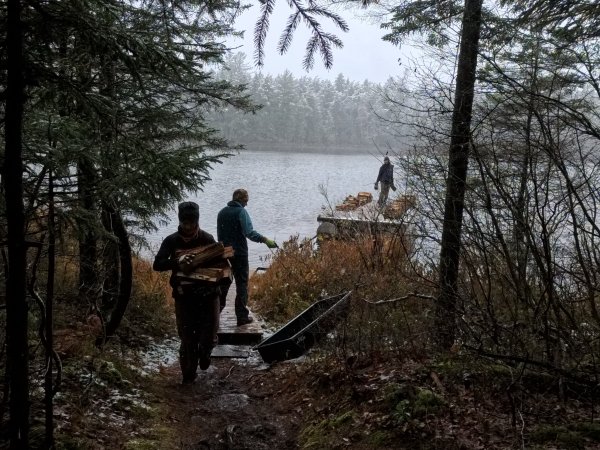 Jordanna, Lars, and Rachael schlepping wood.