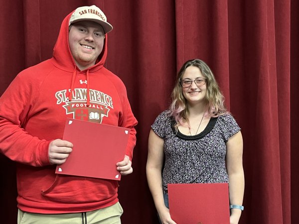 Students hold certificates