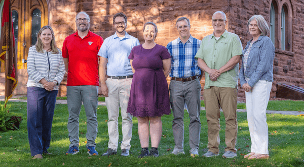 President Morris and Dean Del Rossi accompanied by the 2026 promoted faculty. 