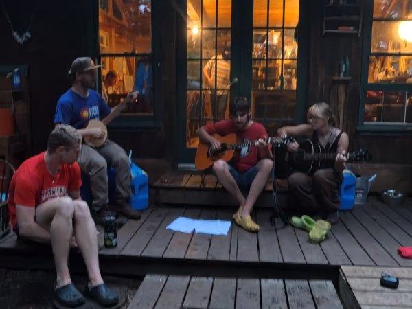 A handful of Arcadians congregating outside of the kitchen, featuring Will Chalfant and Emily Helterline noodling.