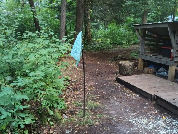 The community flag standing proudly in front of the kitchen after being rescued from Dead Creek.