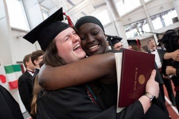 Students hugging at graduation
