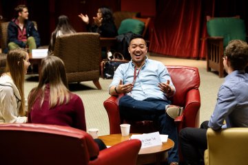 Alumnus speaking with students