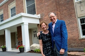 Bill and Lynn Fox stand in front of the newly named Fox Hall.