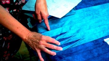 woman's hands with quilting material
