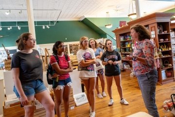 Jill Breit chats with five Saint Lawrence University students at the Traditional Arts in Upstate New York Center in Canton, New York. 