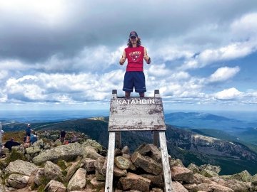 Laurentian standing on mountain sign