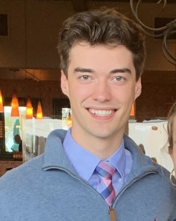 Matthew Derouchie, class of twenty-twenty-two, wearing a shirt and tie and a light blue quarter-zip sweater.