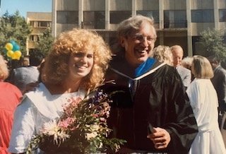 Liz Regosin in 1989 holds a bouqet of flowers and stands next to Doctor Larry Levine following her college graduation from University of California at Berkeley.