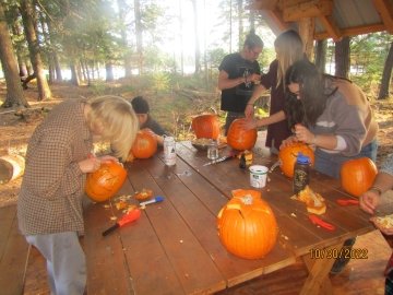 Arcadians work hard on their spooky pumpkins.