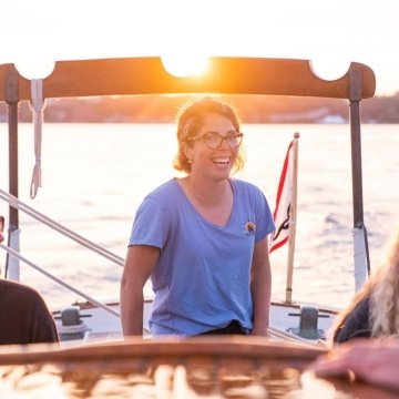 Hannah Langsdale on her boat with sunset behind her