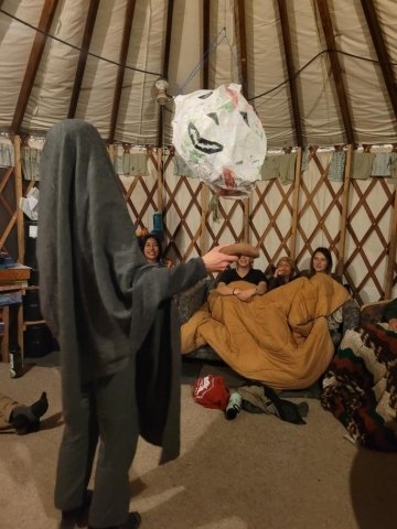 The piñata hanging in the community yurt. 