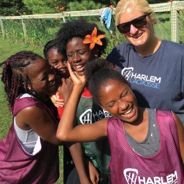 Greta Massey with young lacrosse athletes from NYC