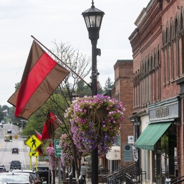 Image of the town of Canton with Saint Lawrence University Flags hanging from the Light Posts.