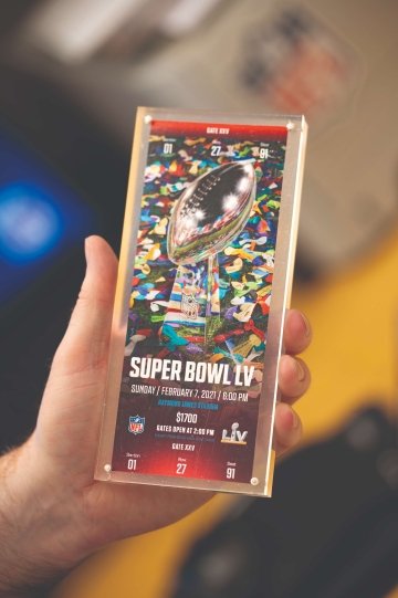 Brian McCarthy holds a Super Bowl ticket encased in a clear plastic protective case.