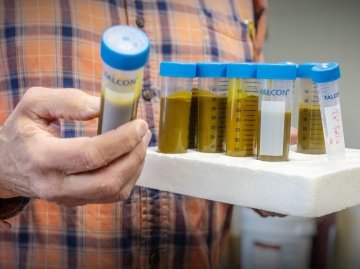 Joe Elrichman holds a tray of hop extracts in test tubes. 